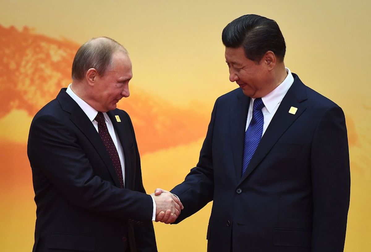 Russian President Vladimir Putin shakes hands with Chinese President Xi Jinping as he arrives for the Asia-Pacific Economic Cooperation leaders meeting Nov. 11, 2014. GREG BAKER/AFP VIA GETTY IMAGES