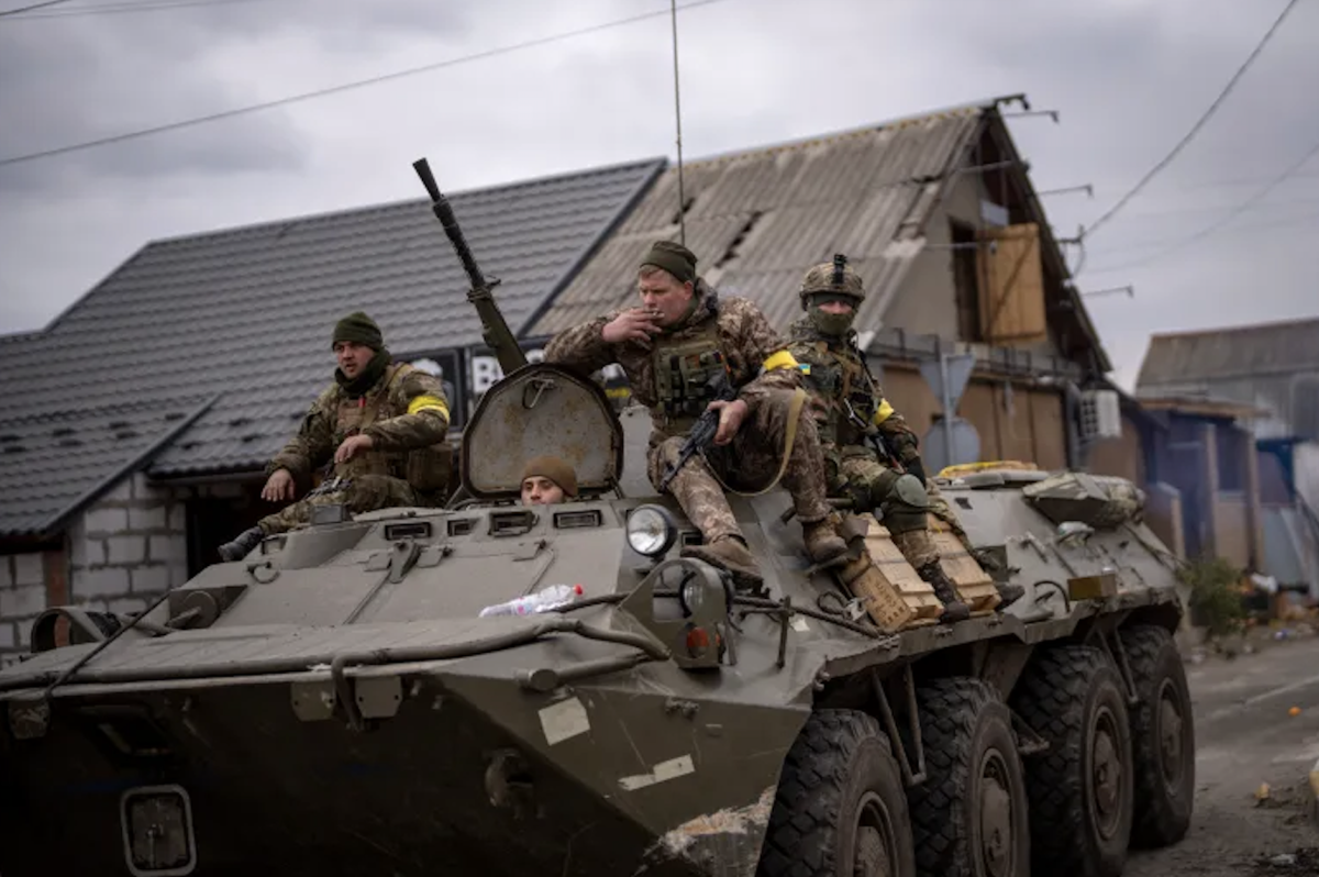 Ukrainian soldiers drive on an armoured military vehicle in the outskirts of Kyiv, Ukraine, on March 5, 2022