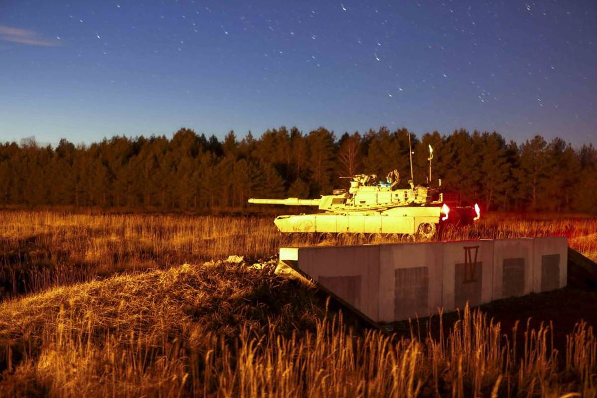 Soldiers in an Army M1A2 Abrams tank conduct night-fire training at Drawsko Pomorskie, Poland, Jan. 29, 2022