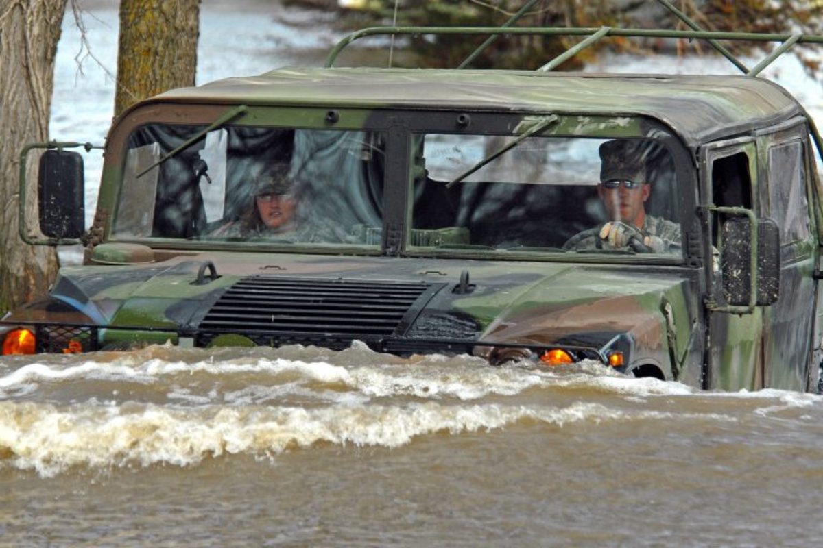 Army personnel drive through flood waters in Fort Ransom, ND.
