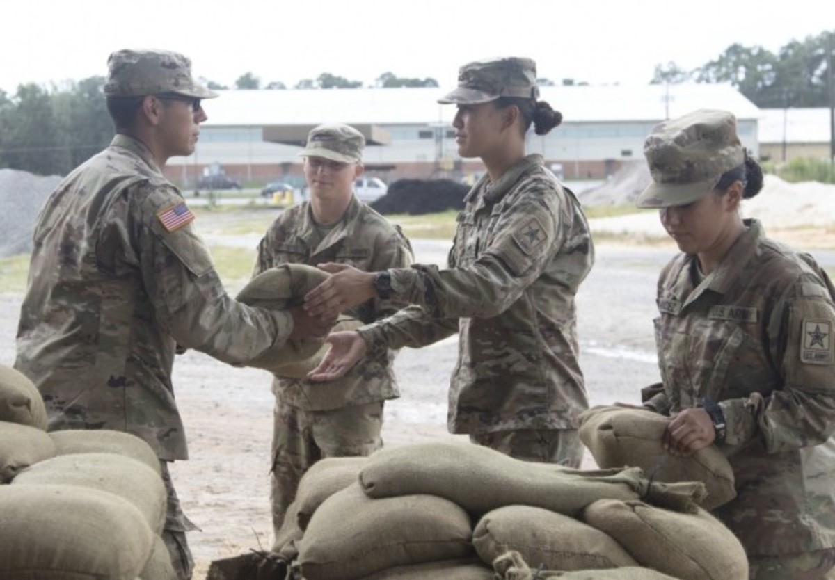 Trainees at Fort Jackson, S.C., stack sandbags to be used throughout the hurricane season on Sept. 5, 2019. The Army recently introduced a new directive to prepare the service's installations against the growing threat of climate change. (Alexandra Shea)