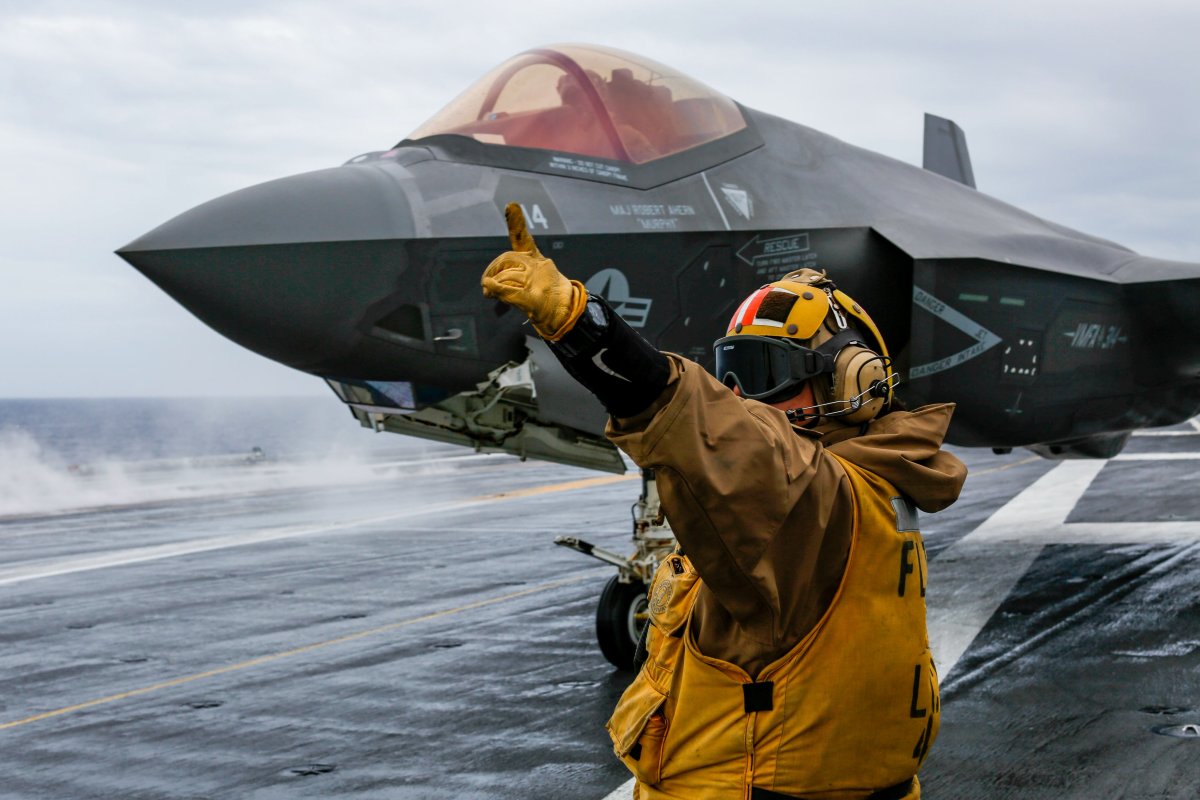An F35C is directed on the flight deck of the USS Abraham