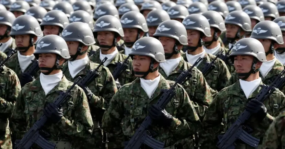 Members of Japan's Self-Defence Forces' airborne troops stand at attention