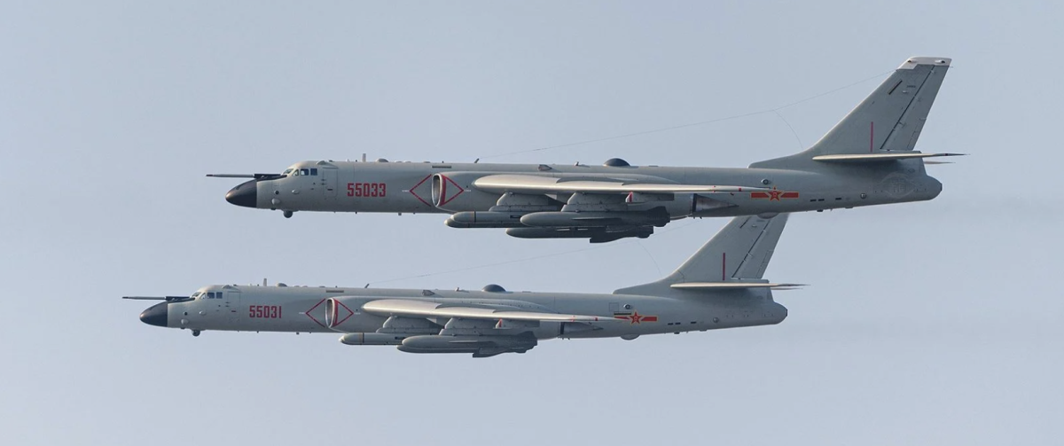 A pair of Chinese H-6K or H-6N in flight carrying cruise missiles